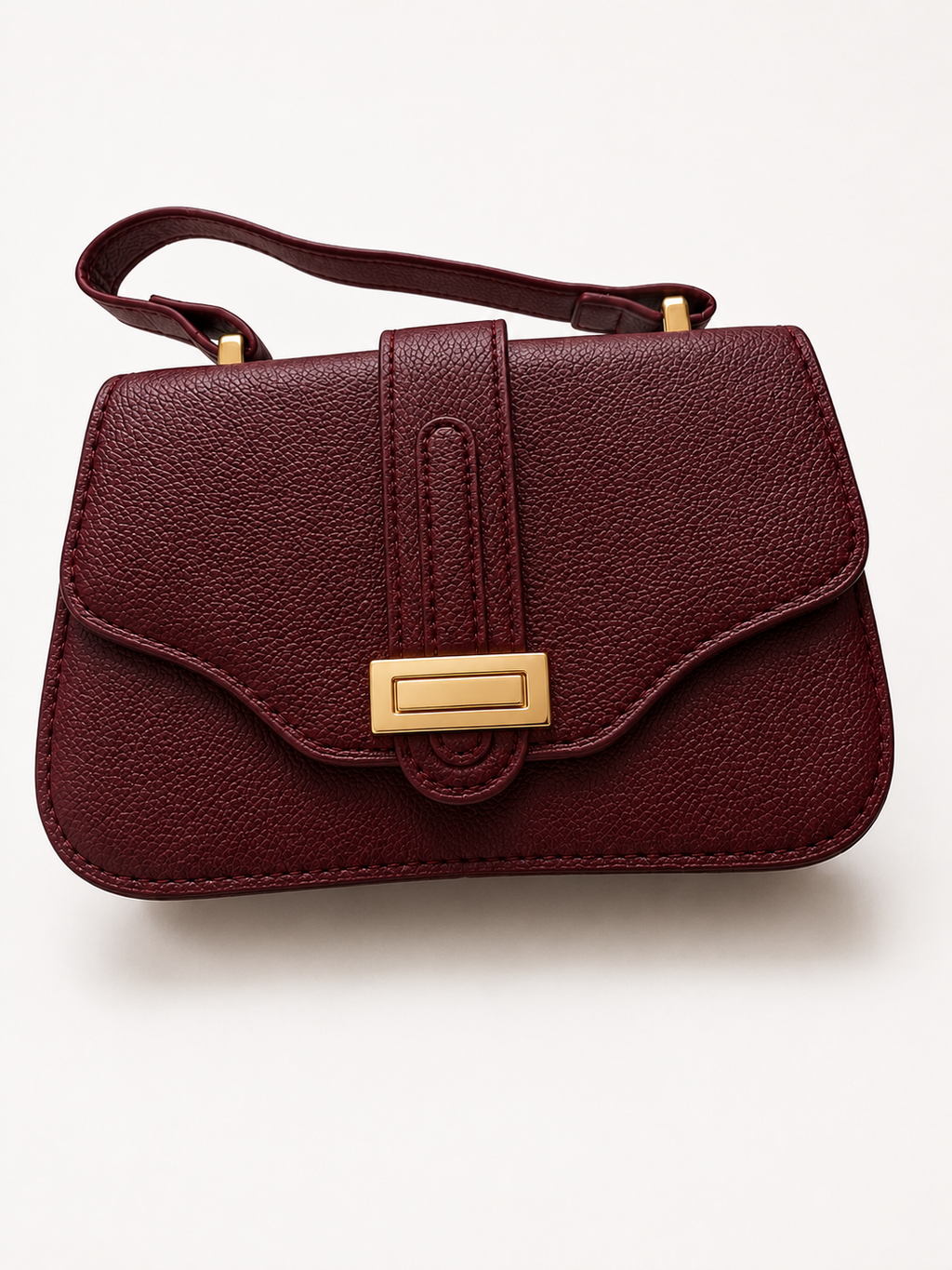 Elegant burgundy textured top handle crossbody handbag with gold hardware for women.