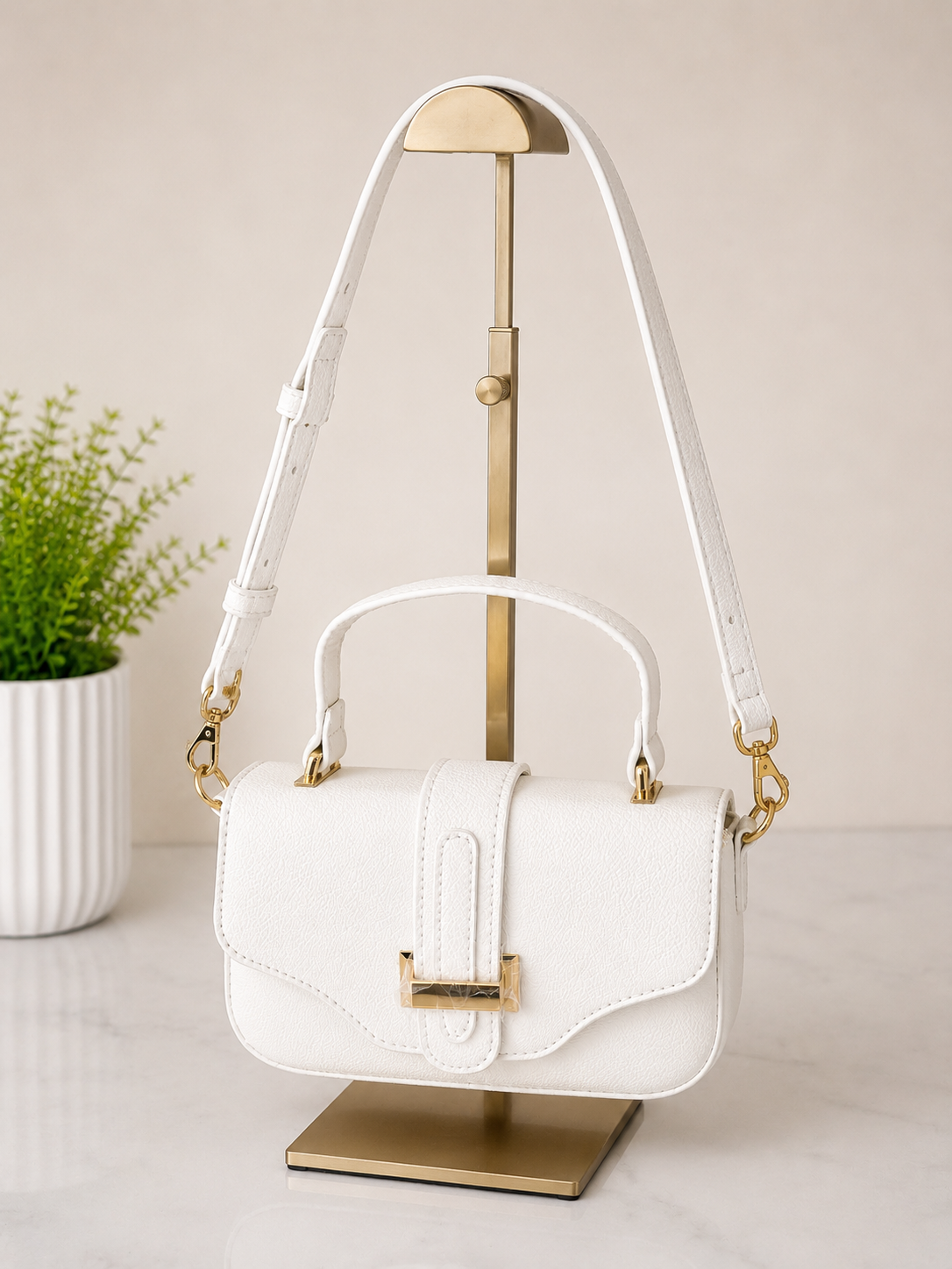 White

Elegant white textured top handle crossbody handbag with gold hardware for women.